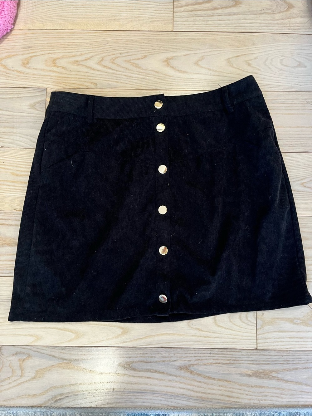 Black corduroy mini skirt with button front